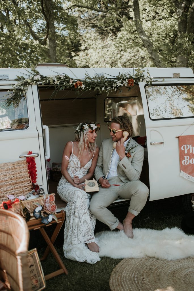 wedding couple having fun in a vintage camper booth 